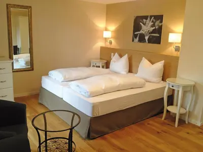 Ein Bett oder Betten in einem Zimmer der Unterkunft Alpenhof Landhotel Restaurant