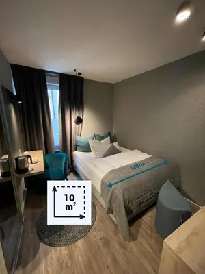 Ein Bett oder Betten in einem Zimmer der Unterkunft Hotel Falkenturm