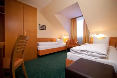 Ein Bett oder Betten in einem Zimmer der Unterkunft Hotel Grünwald