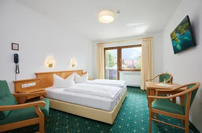 Ein Bett oder Betten in einem Zimmer der Unterkunft Hotel Garni Zugspitz