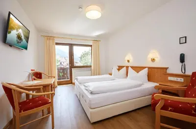 Ein Bett oder Betten in einem Zimmer der Unterkunft Hotel Garni Zugspitz