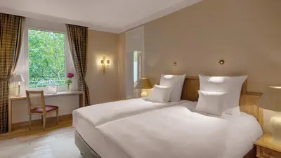 Ein Bett oder Betten in einem Zimmer der Unterkunft Hotel Excelsior München