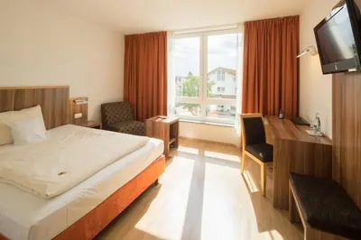 Ein Bett oder Betten in einem Zimmer der Unterkunft Hotel Meridian ***superior