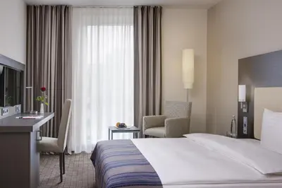 Ein Bett oder Betten in einem Zimmer der Unterkunft IntercityHotel Ingolstadt