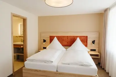 Ein Bett oder Betten in einem Zimmer der Unterkunft Hotel Sixt