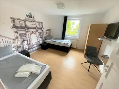 Ein Bett oder Betten in einem Zimmer der Unterkunft Olympia Pension