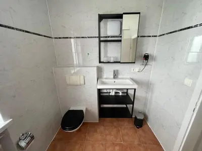 Ein Badezimmer in der Unterkunft Olympia Pension