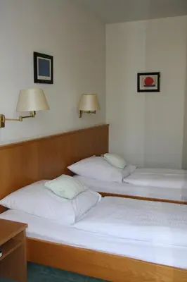 Ein Bett oder Betten in einem Zimmer der Unterkunft Hotel Stadt Pasing