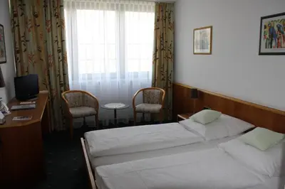 Ein Bett oder Betten in einem Zimmer der Unterkunft Hotel Stadt Pasing