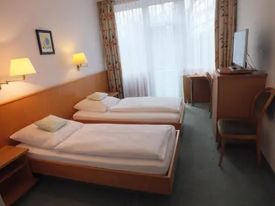 Ein Bett oder Betten in einem Zimmer der Unterkunft Hotel Stadt Pasing