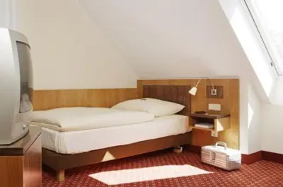 Ein Bett oder Betten in einem Zimmer der Unterkunft Hotel Landgasthof Gschwendtner