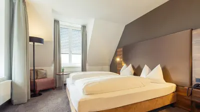 Ein Bett oder Betten in einem Zimmer der Unterkunft Altstadthotel Kneitinger, Abensberg