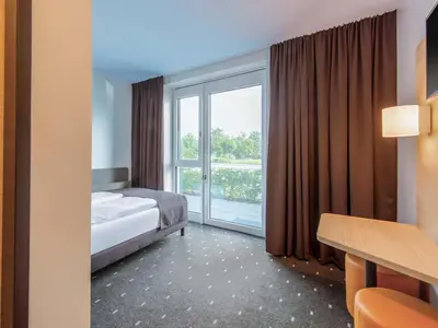 Ein Bett oder Betten in einem Zimmer der Unterkunft B&B Hotel Augsburg-Nord