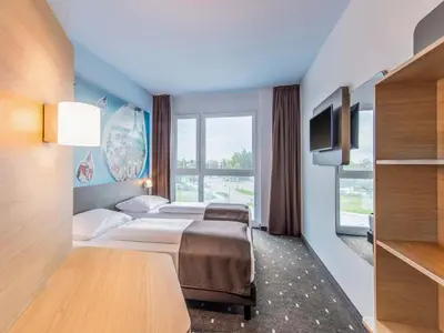 Ein Bett oder Betten in einem Zimmer der Unterkunft B&B Hotel Augsburg-Nord