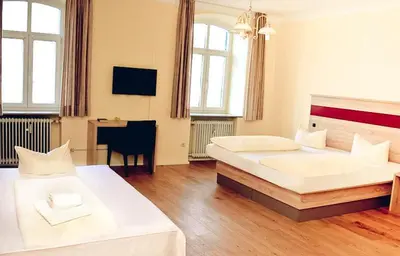 Ein Bett oder Betten in einem Zimmer der Unterkunft Hotel-Gasthof Flötzinger Bräu
