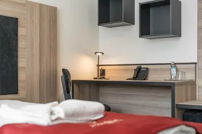 Ein Bett oder Betten in einem Zimmer der Unterkunft Abasto Hotel Dachau