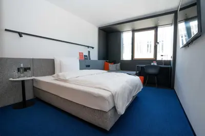 Ein Bett oder Betten in einem Zimmer der Unterkunft GREFIS Hotel München-Gräfelfing