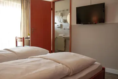 Ein Bett oder Betten in einem Zimmer der Unterkunft Hotel Bastei