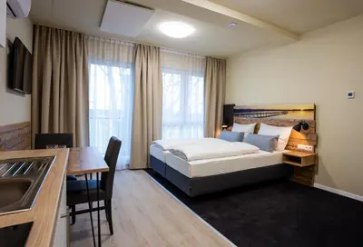 Ein Bett oder Betten in einem Zimmer der Unterkunft Gästehaus - Boardinghouse Magnetsried