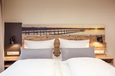 Ein Bett oder Betten in einem Zimmer der Unterkunft Gästehaus - Boardinghouse Magnetsried