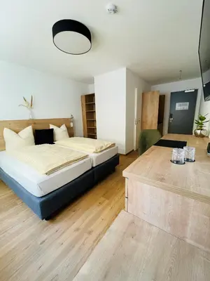 Ein Bett oder Betten in einem Zimmer der Unterkunft Creo München Süd