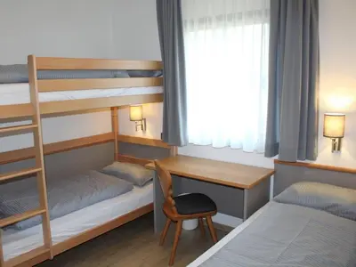 Ein Bett oder Betten in einem Zimmer der Unterkunft Ferienhaus Nr 136, Typ A, Feriendorf Hochbergle, Allgäu