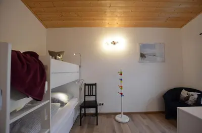 Ein Bett oder Betten in einem Zimmer der Unterkunft Feriendorf Via Claudia Haus 58 Alpenliebe