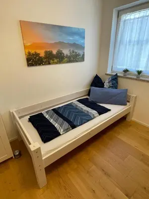 Ein Bett oder Betten in einem Zimmer der Unterkunft Ferienwohnung Hochriesblick