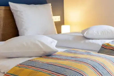 Ein Bett oder Betten in einem Zimmer der Unterkunft Ferienwohnungen Friedenshöhe in Oberammergau