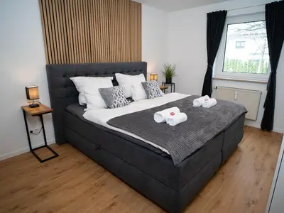 Ein Bett oder Betten in einem Zimmer der Unterkunft MOREHOME Sonnenterrasse & Heimkino Switch 2