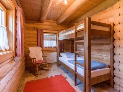 Ein Bett oder Betten in einem Zimmer der Unterkunft Audorfer Blockhaus
