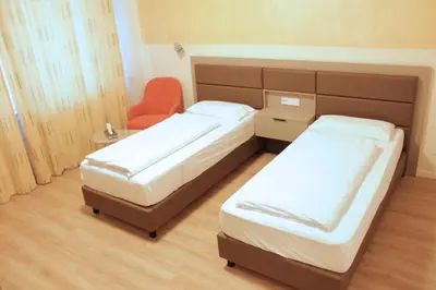 Ein Bett oder Betten in einem Zimmer der Unterkunft Isar City Hotel
