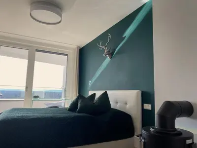 Ein Bett oder Betten in einem Zimmer der Unterkunft ALPEN-PANORAMA SUITE - Einzigartige Privatsuite hoch über München, 12tes OG, Alpenblick, Loggia, Whirlpool, 15 Minuten zum Zentrum, Ruhe und Erholung in der Stadt München für privat und geschäftlich Reisende
