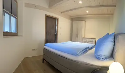 Ein Bett oder Betten in einem Zimmer der Unterkunft Ferienwohnung Atelier Simetsberg