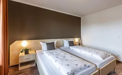 Ein Bett oder Betten in einem Zimmer der Unterkunft Brauereigasthof Hofmark