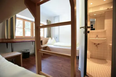 Ein Bett oder Betten in einem Zimmer der Unterkunft BLSV Sportcamp direkt am Kurvenlift!