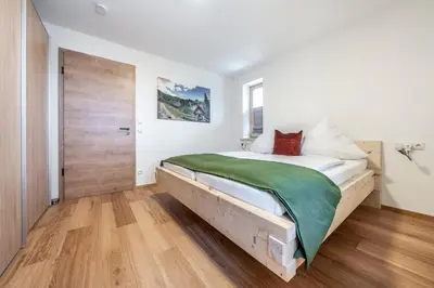 Ein Bett oder Betten in einem Zimmer der Unterkunft Alpenrose Ferienwohnungen