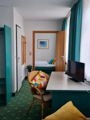 Ein Bett oder Betten in einem Zimmer der Unterkunft Hotel am Friedberger See