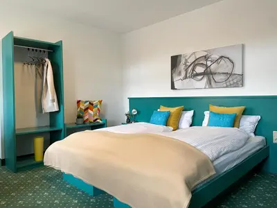 Ein Bett oder Betten in einem Zimmer der Unterkunft Hotel am Friedberger See