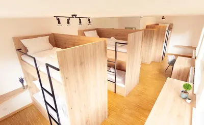 Ein Bett oder Betten in einem Zimmer der Unterkunft Henrys Sleeping am Augsburger Eiskanal