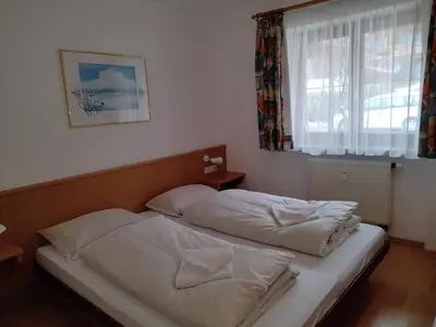 Ein Bett oder Betten in einem Zimmer der Unterkunft ciao-aschau Grenzhub FeWo 308 Förster