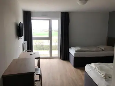 Ein Bett oder Betten in einem Zimmer der Unterkunft FirstSleep Landshut