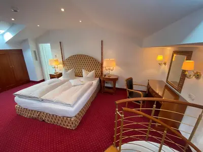Ein Bett oder Betten in einem Zimmer der Unterkunft Hotel Alpenhof Bayrischzell