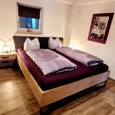 Ein Bett oder Betten in einem Zimmer der Unterkunft Ferienwohnung Am Hochfeld