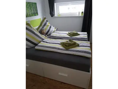Ein Bett oder Betten in einem Zimmer der Unterkunft NEU Apartment am Birkenfeld Allgäu Kaufbeuren